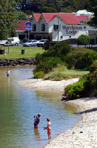 two people fishing in the water on a river at Best Western Burnie - Murchison Lodge in Somerset