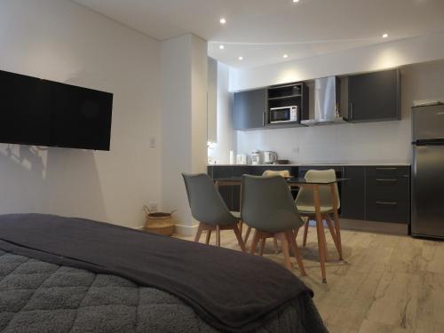 a bedroom with a kitchen with a table and chairs at Residencias Roque Suarez in Mar del Plata