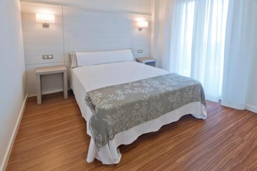a bedroom with a large bed in a room at Apartamentos Norte 14 in Salou