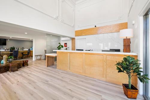 an office lobby with wooden counters and a dining area at Hotel Huntington in Duarte