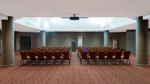 an empty room with a bunch of chairs in it at Radisson Blu Mammy Yoko Hotel in Freetown