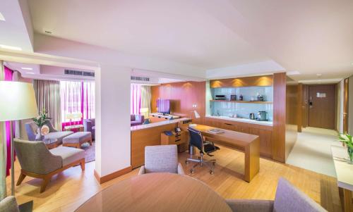 a living room with a kitchen and a dining room at Radisson Blu Hotel, Kuwait in Kuwait