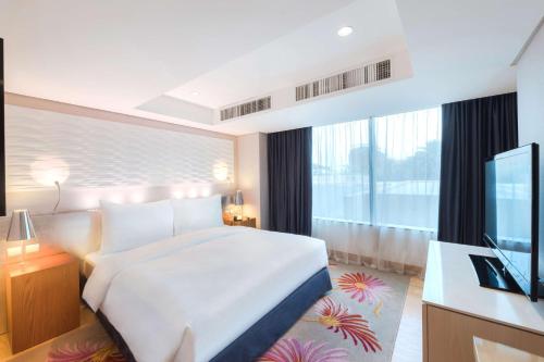 a hotel room with a bed and a television at Radisson Blu Hotel, Kuwait in Kuwait