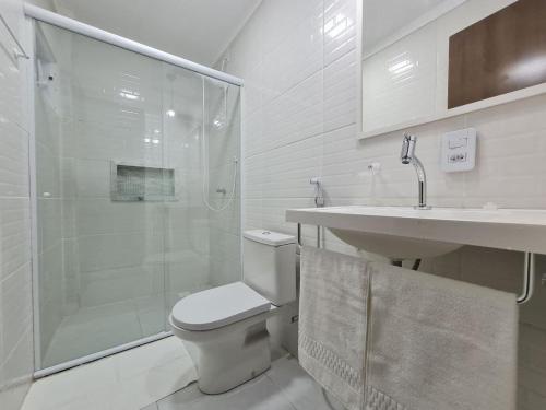 a bathroom with a shower and a toilet and a sink at Hotel Aveiro in Parnaíba