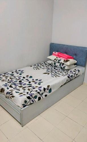 a bedroom with a bed with a blue headboard at Rosdan Homestay in Bachok