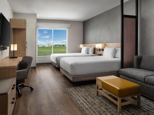 a hotel room with two beds and a desk and a couch at Hyatt Place Amarillo-West in Amarillo