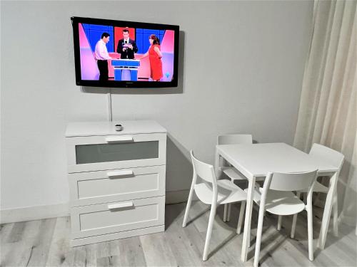 a room with a table and a tv on a wall at Ocean Front Units at Miami Beach in Miami Beach