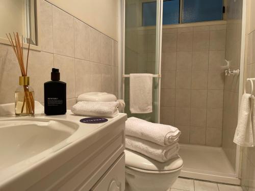 a bathroom with a sink and a toilet and a shower at Skippers Apollo Bay in Apollo Bay