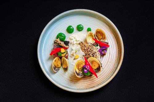 a plate of food with mushrooms and vegetables on it at Pullman Reef Hotel Casino in Cairns