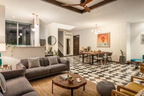 a living room with a couch and a table at La Zamora, 3BHK Villas near Vagator & Anjuna Beach, North Goa with Private Pool, Garden, Terrace & Security in Assagao