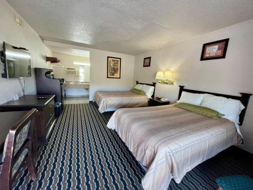 a hotel room with two beds and a television at Washington Burgess Inn in West Point