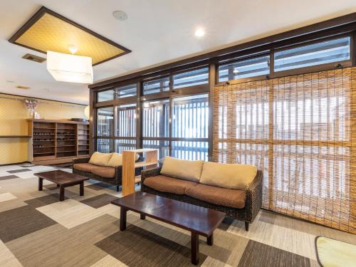 a living room with a couch and a table at Kousen Annex Kazeya Group in Nara