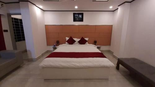 a bedroom with a large bed in a room at The Grand Mafi Hotel & Suites in Sylhet