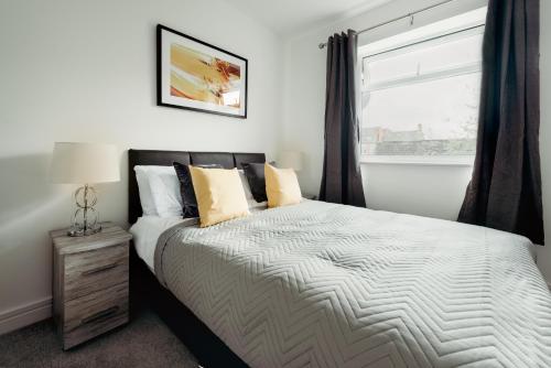 a bedroom with a large bed and a window at Arlan Apartments Comfort and Ease, Hinckley in Hinckley