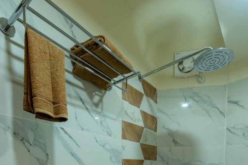 a bathroom with a towel rack with towels at HOTEL ROI-KI in Shillong