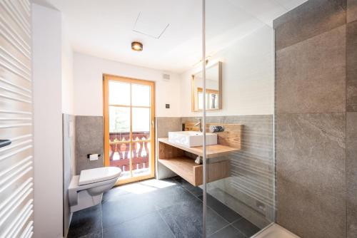 a bathroom with a toilet and a sink at Spielberghaus in Saalbach-Hinterglemm