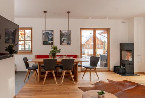 a living room with a dining room table and chairs at Luxury Chalets Gradenbach near Schladming in Haus im Ennstal