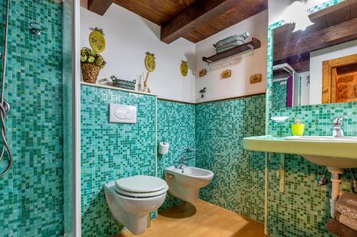 a bathroom with a toilet and a sink at Alghero Old Town Gem - Emerald in Alghero
