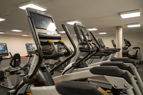a gym with a bunch of cardio machines at Zapfig Living Arlberg in Wald am Arlberg