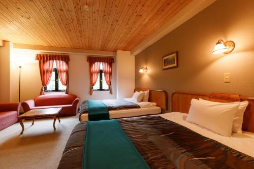Ein Bett oder Betten in einem Zimmer der Unterkunft Tabist More Resort Keyaki no Ki Hakuba