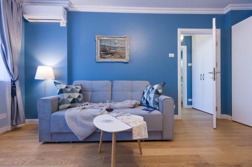 a blue living room with a couch and a table at Luxury Cosy Apartment Central- Unirii Square/Old Town Adela Accommodation in Bucharest