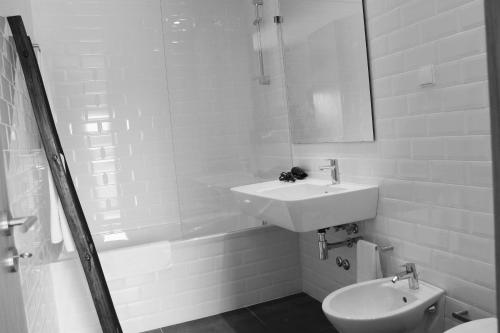 a bathroom with a sink and a toilet at Lousada Country Hotel in Lousada
