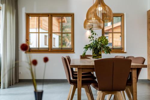 a dining room with a wooden table and chairs at Luxury Chalets Gradenbach near Schladming in Haus im Ennstal