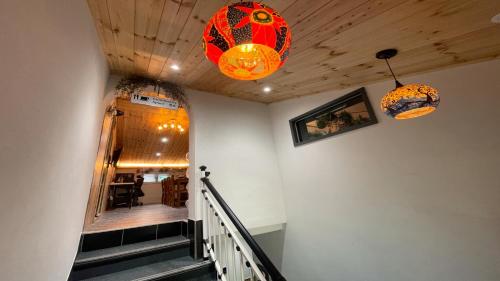 a hallway with two lights and a staircase at The Road Hotel in Seoul