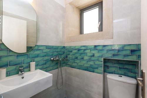a bathroom with a sink and a toilet and a mirror at Villa Stone Thromila in Sellía