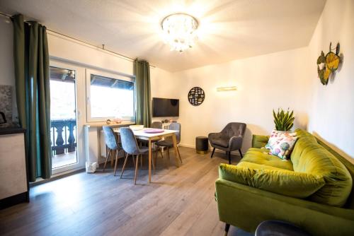 a living room with a couch and a table at Ferienwohnungen Hopfen und Malz in Fichtelberg