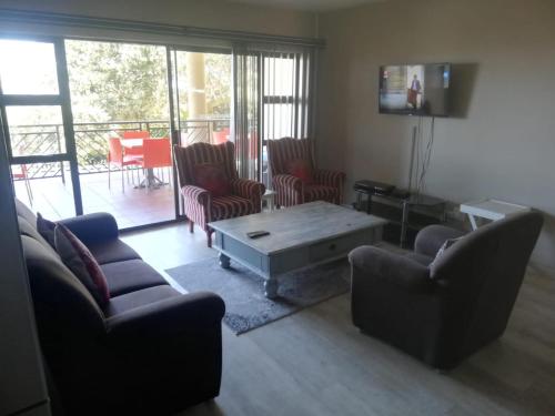 a living room with two couches and a coffee table at Portofino Unit 22 in Margate
