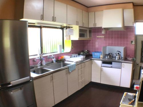 a kitchen with a sink and a refrigerator at YADO OMIYA / Vacation STAY 45672 in Kamogawa