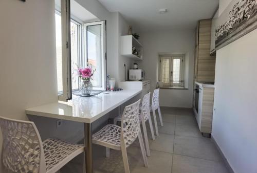 a kitchen with a table with chairs and a counter top at Lux - Apartment BCN in Budva