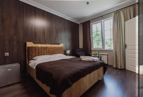 a bedroom with a large bed and a window at Mehsul Recreational Center in İsmayıllı