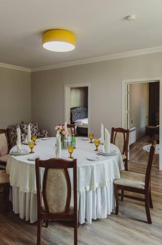 a dining room with a white table and chairs at Mehsul Recreational Center in İsmayıllı
