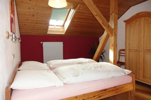 a bed with white pillows in a room at Ferienwohnung Karch in Beilngries
