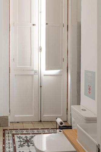 a bathroom with a white toilet and a sink at Mapango Small Rooms in Santa Cruz de Tenerife