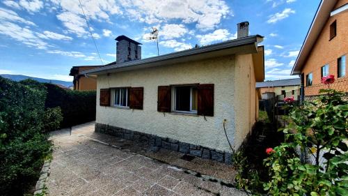 a white house with windows and a sky at EL CHALET in Rascafría