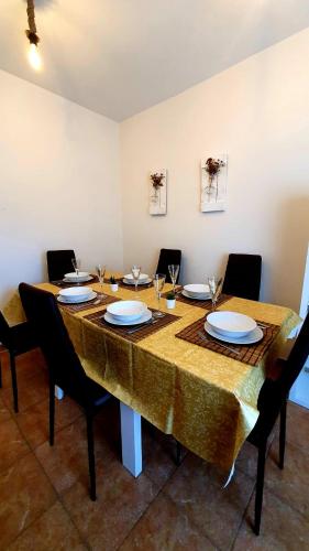 a large wooden table with chairs and plates on it at EL CHALET in Rascafría