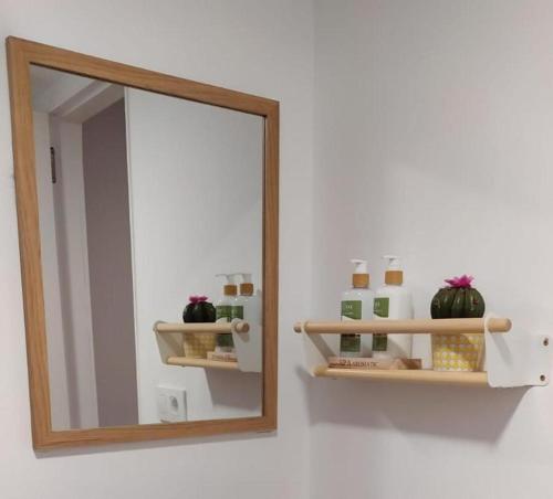 a mirror on a wall in front of a bathroom at Estudio Casco Vello in Vigo