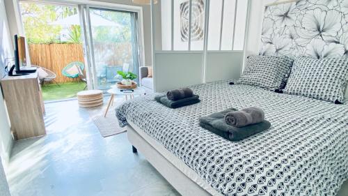 une chambre avec un lit avec deux serviettes dessus dans l'établissement Le Châtaignier Modern center parking garden, à Antibes