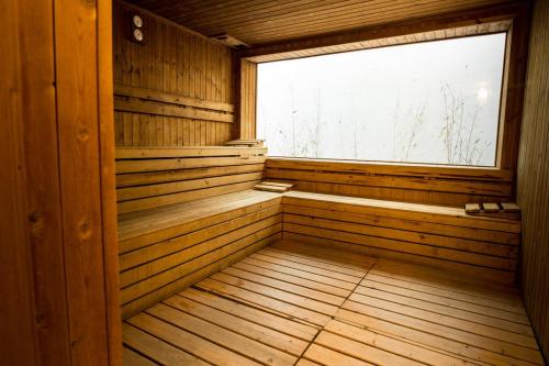 an empty sauna with a window and wooden walls at L'Antico Uliveto in Porto Potenza Picena