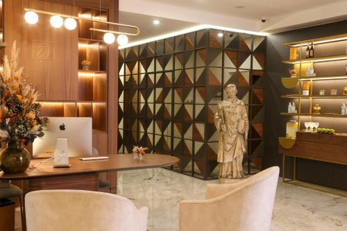 a lobby with a statue of a man on a wall at Vincci Alfama in Lisbon