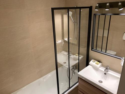 a bathroom with a shower and a sink at City Loft Apparthotel in Dijon