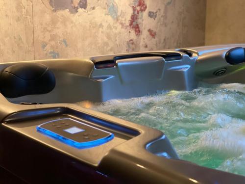 a hot tub filled with water with a cell phone in it at Villa Lovran, heated pool and Spa in Lovran