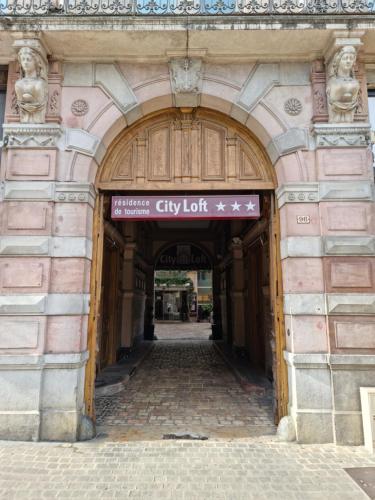 an entrance to a building with a city lift sign at City Loft Apparthotel in Dijon