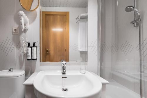 a bathroom with a sink and a toilet and a shower at Crisol Almirante Bonifaz in Burgos