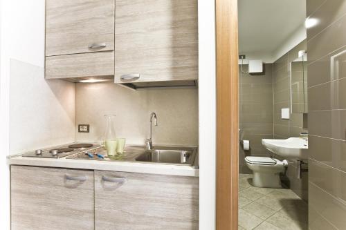 a small bathroom with a sink and a toilet at Hotel Belvedere in Manerba del Garda