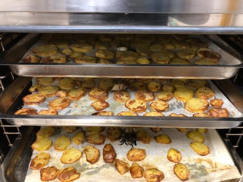 an oven filled with lots of potatoes in it at mammaCristina in Patti