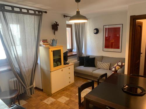 a living room with a couch and a table at Hameau De Jadis in Pré-Saint-Didier